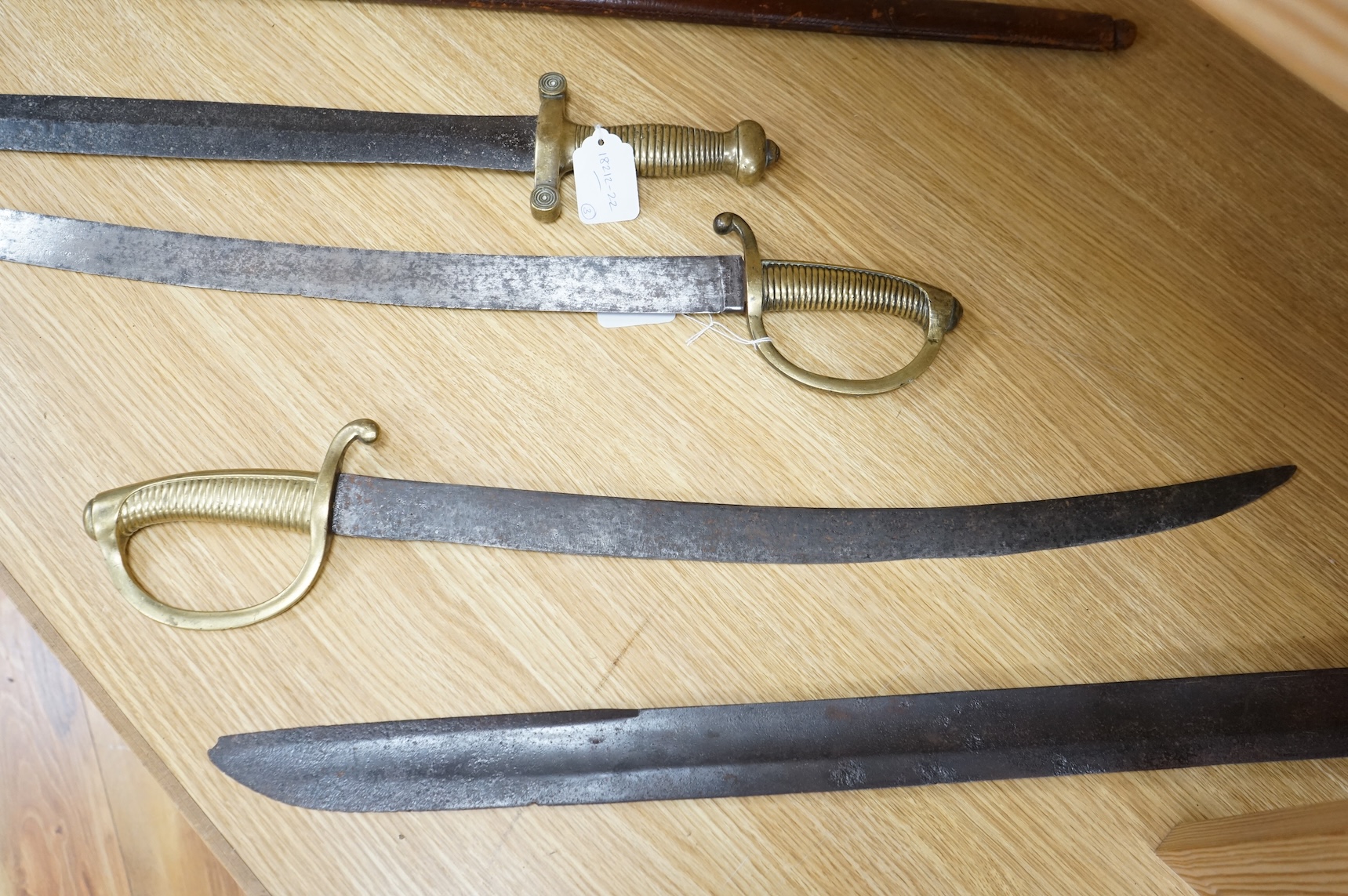 A mid 19th century infantryman’s short sword Gladius with cast brass hilt of universal pattern, stamped 306, together with two Continental infantyman’s side arm briquet, one stamped; M. and R. Boker Remscheid (3)